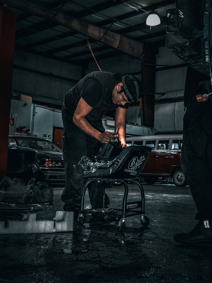 man-in-black-t-shirt-and-black-pants-holding-black-motorcycle-13452914